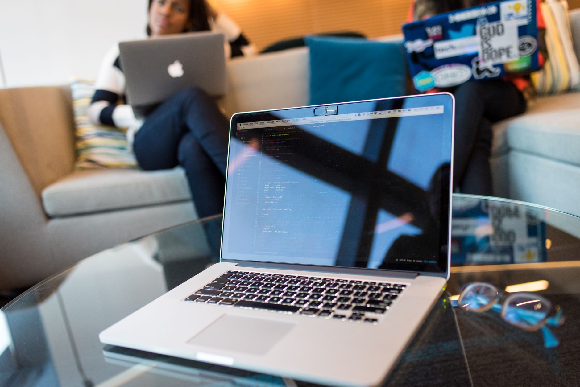 closeup photo of silver macbook pro on table